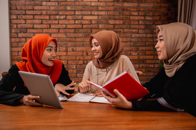 Hijab women chatting with friends about university assignments