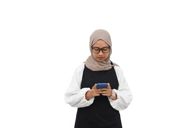 Photo hijab young girl in black apron holding smart phone on white background