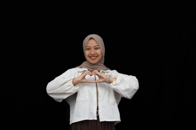 hijab young girl love hand gesture on black background