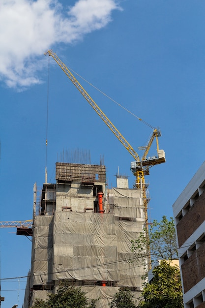 Hijs kraan en gebouw in bouwplaats