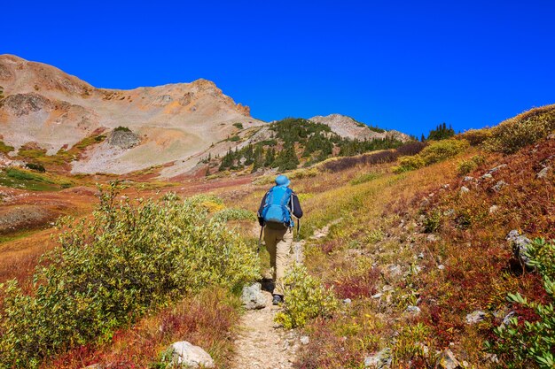 Hike in the autumn mountains. Fall season theme.