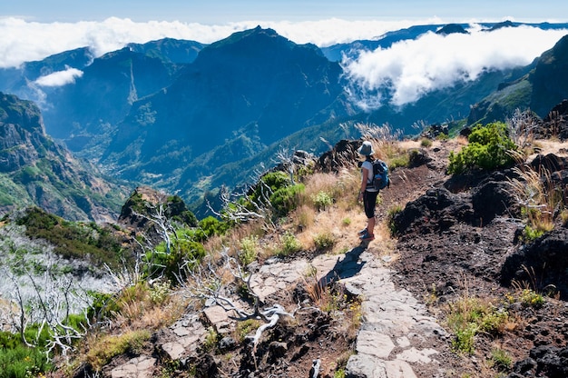 A hiker admires the foggy landscape of the island of Madeira Portugal