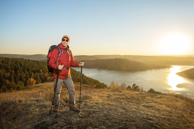 Hiker in Autumn Nature At Sunset Hiking Concept Travel Freedom Lifestyle