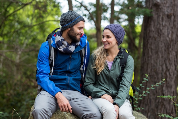 Hiker couple sitting together on rock