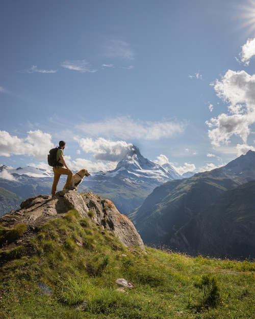 Hiker and dog matterhorn landscape