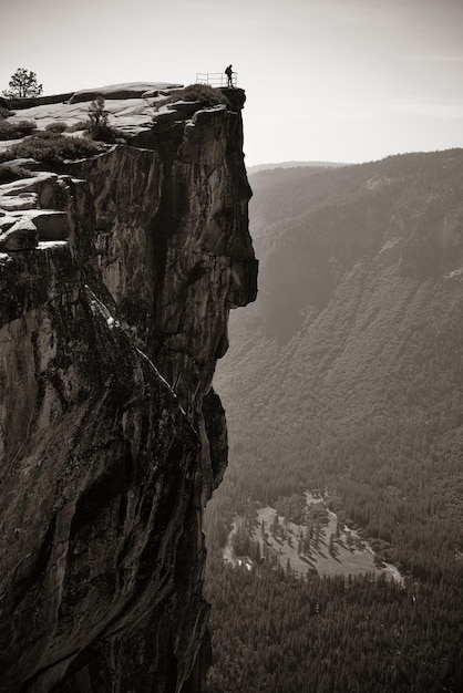 Hiker look down from Taft Point in Yosemite BW.