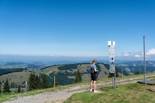 Hiker looking up the signs above in the allgau mountains