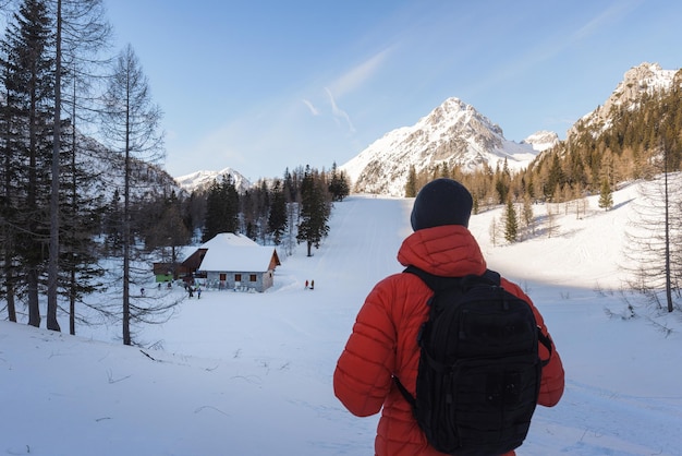 Hiker man enjoy the amazing landscape in snowy mountains