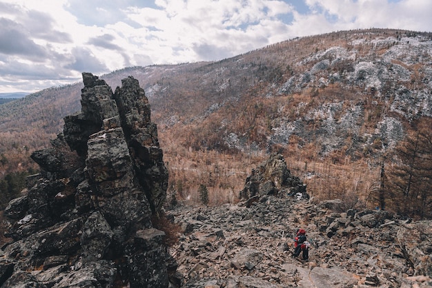 A hiker on a mountain with a mountain in the background