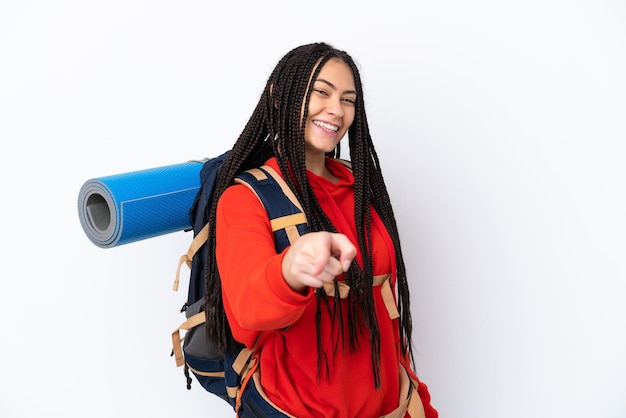 Hiker teenager girl with braids over isolated white background points finger at you with a confident expression