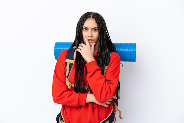 Hiker teenager girl with braids over isolated white background surprised and shocked while looking right