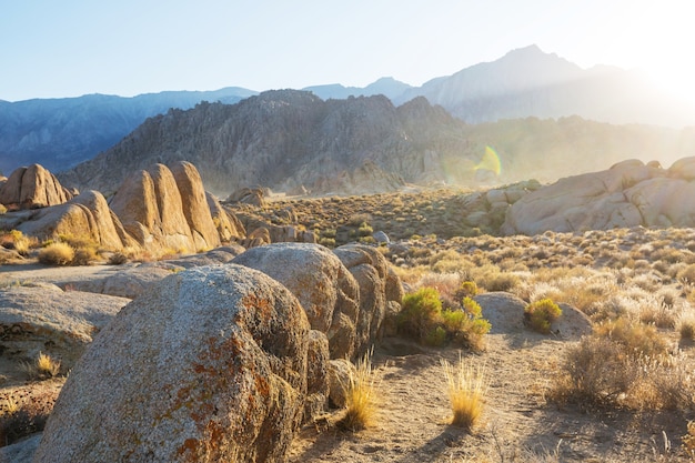 Hiker in unusual stone formations in Alabama hills, California, USA