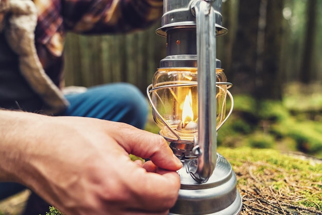 Hiker using a Gasoline lantern in the forest