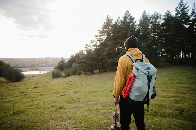 A hiker walking in nature carrying backpack