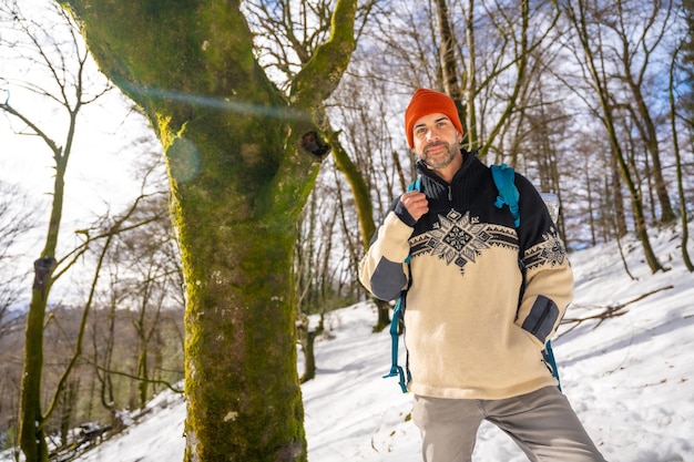 Hiker with backpack on a snow trekking winter adventure nature activity