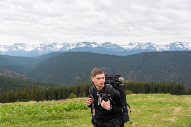 Hiker with equipment spends time hiking in the mountains