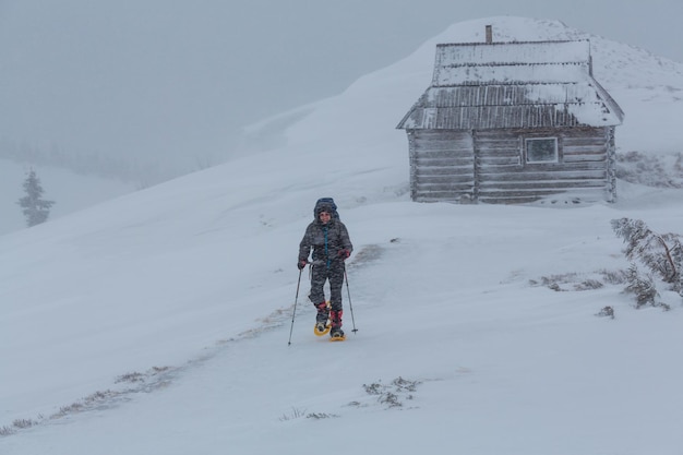 Hiker with snowshoes in winter