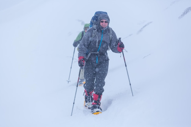 Hiker with snowshoes in winter