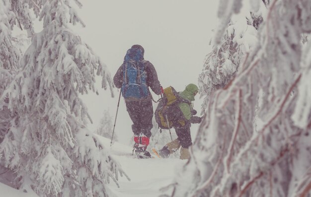 Hiker with snowshoes in winter