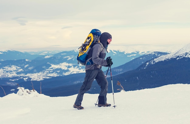 Hiker with snowshoes in winter