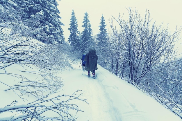 Hiker with snowshoes in winter