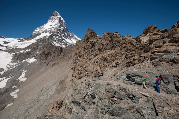 Hikers at the foot of Mount Cervin Matterhorn Zermatt Switzerland