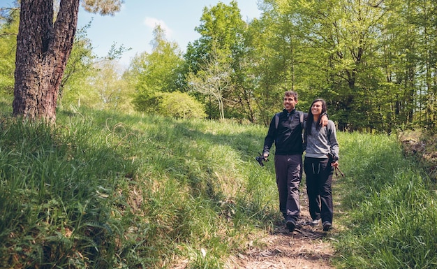 Hikers walking embraced