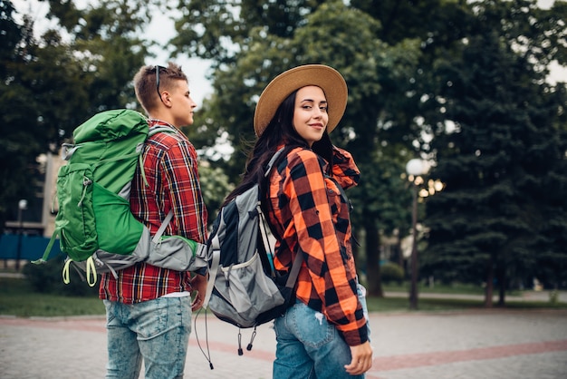 Hikers with backpacks traveling in tourist town