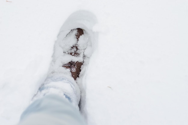 Hiking boots against snow copy space brown shoes came in a large depth of snow