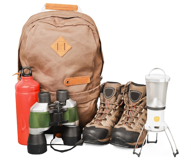 Photo hiking boots, backpack and map  on background