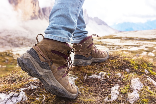 Foto primo piano delle scarpe da trekking. turista che cammina sul sentiero. dolomiti, italia