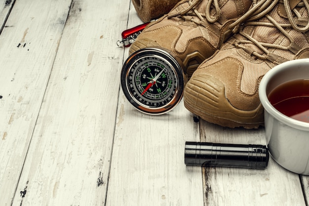 Hiking boots, compass and knife. hiking outdoor equipment