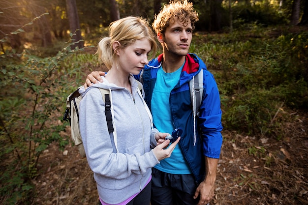 Hiking couple checking the compass