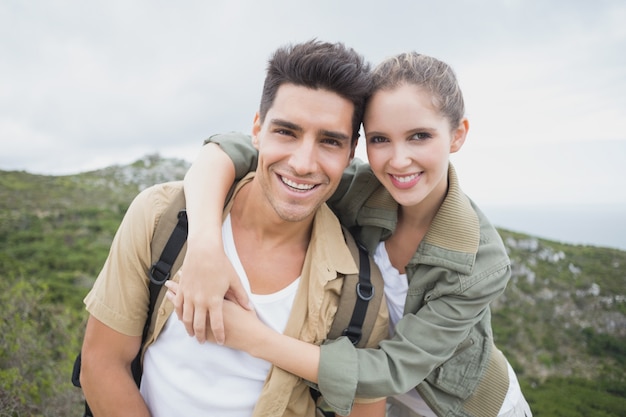 Hiking couple standing on mountain terrain