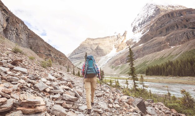 Hiking man in Canadian mountains. Hike is the popular recreation activity in North America. There are a lot of picturesque trails.