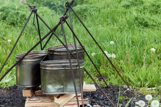 Hiking pot bowler in the bonfire in cauldron at the stake\
traveling tourism picnic cooking cooking at the stake in a cauldron\
fire and smoke