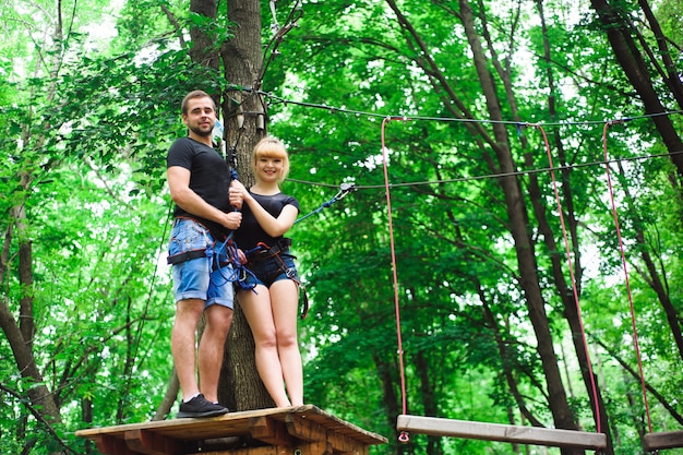 Hiking in the rope park two young people.