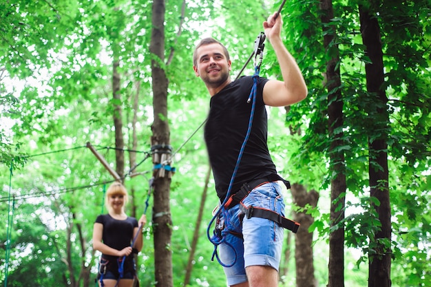 Hiking in the rope park two young people.