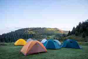 Photo hiking tents in the mountains set outdoor. colorful trekking tents outsige