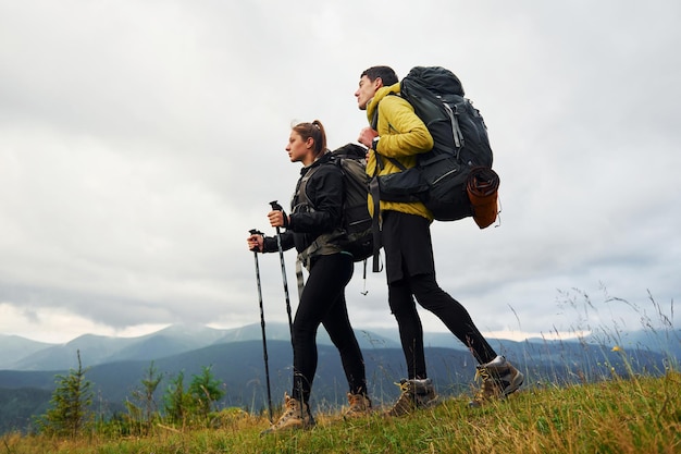 Hiking together Woman and man Majestic Carpathian Mountains Beautiful landscape of untouched nature