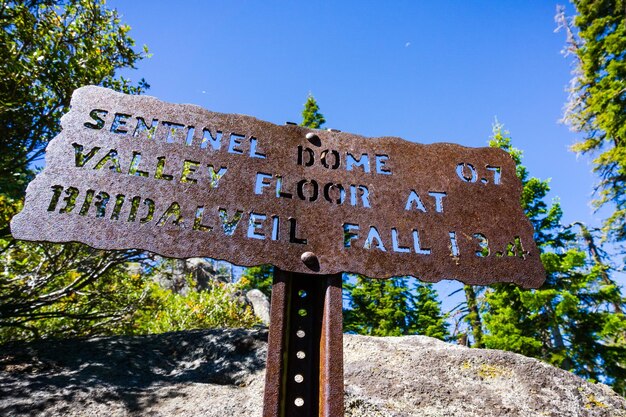 Hiking trail sign posted on the trail to Sentinel Dome close to Glacier Point showing points of interest and distances Yosemite National Park Sierra Nevada mountains California