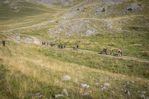 Hiking trekking in mountains leading group