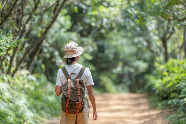 Hiking woman go trekking in the forest