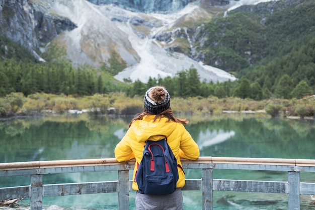 Hiking young woman traveler looking beautiful landscape at Yading Nature Reserve, Travel lifestyle concept