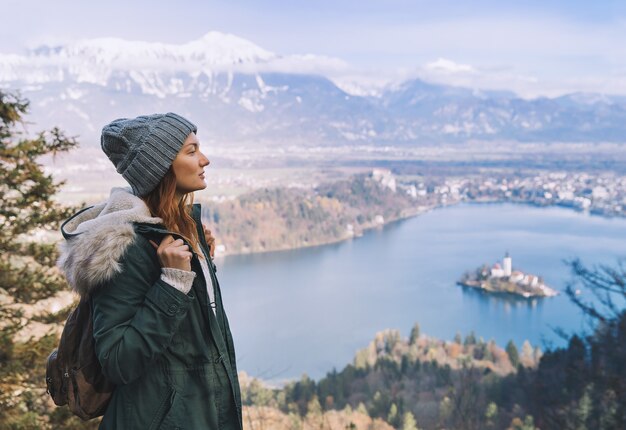 Hiking young woman with alps mountains and alpine lake on background Travel Slovenia Europe