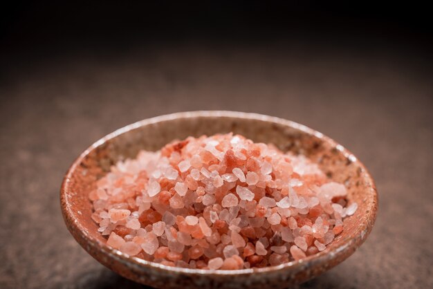 Himalayan pink salt in a bowl on table.