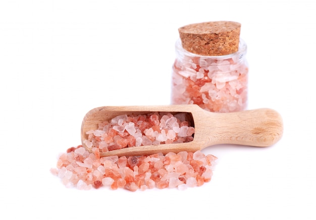 Himalayan pink salt in glass jar isolated on white background