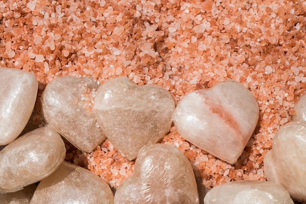 Фото Гималайская розовая соль в кристаллах и камнях в форме сердца.