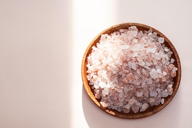 Himalayan pink salt in wooden bowl close up