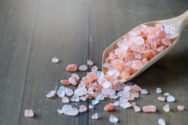 Himalayan Rock pink Salt on wood spoon on wood